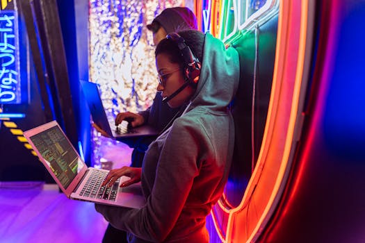 Man in Gray Hoodie Using Macbook Pro